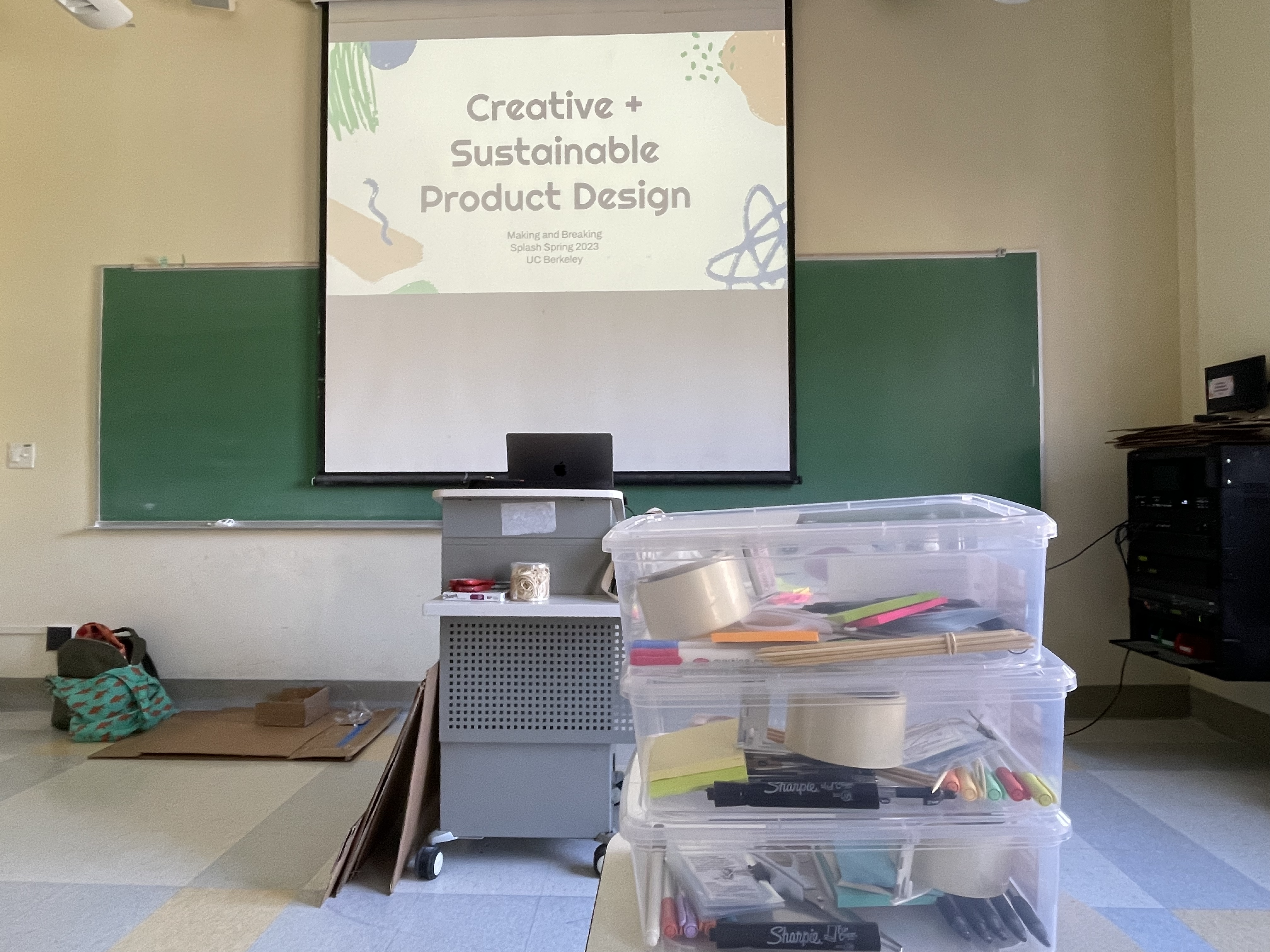 title slide with class name behind boxes of materials for the class